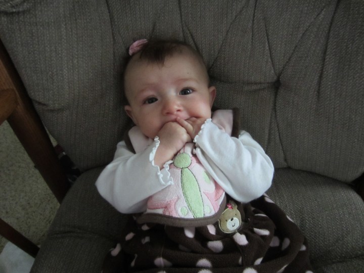 Ginny, as always, sucking on her hands