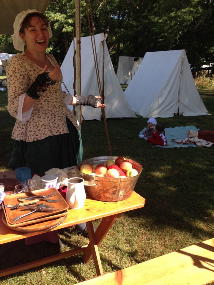 Preparing to cook with a bucket full of vegetables and apples. The babies entertained themselves on their blanket in the background.