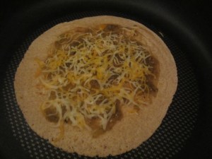 Quasadilla in the skillet, before adding the fish sticks and veggies.